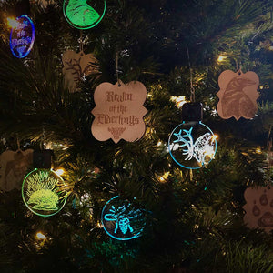 Laser cut / engraved Realm of the Elderling ornaments shown in both our Birch ply and LED puck style hanging ornaments.